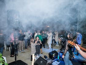 Lots of people dancing and having fun on a dancefloor