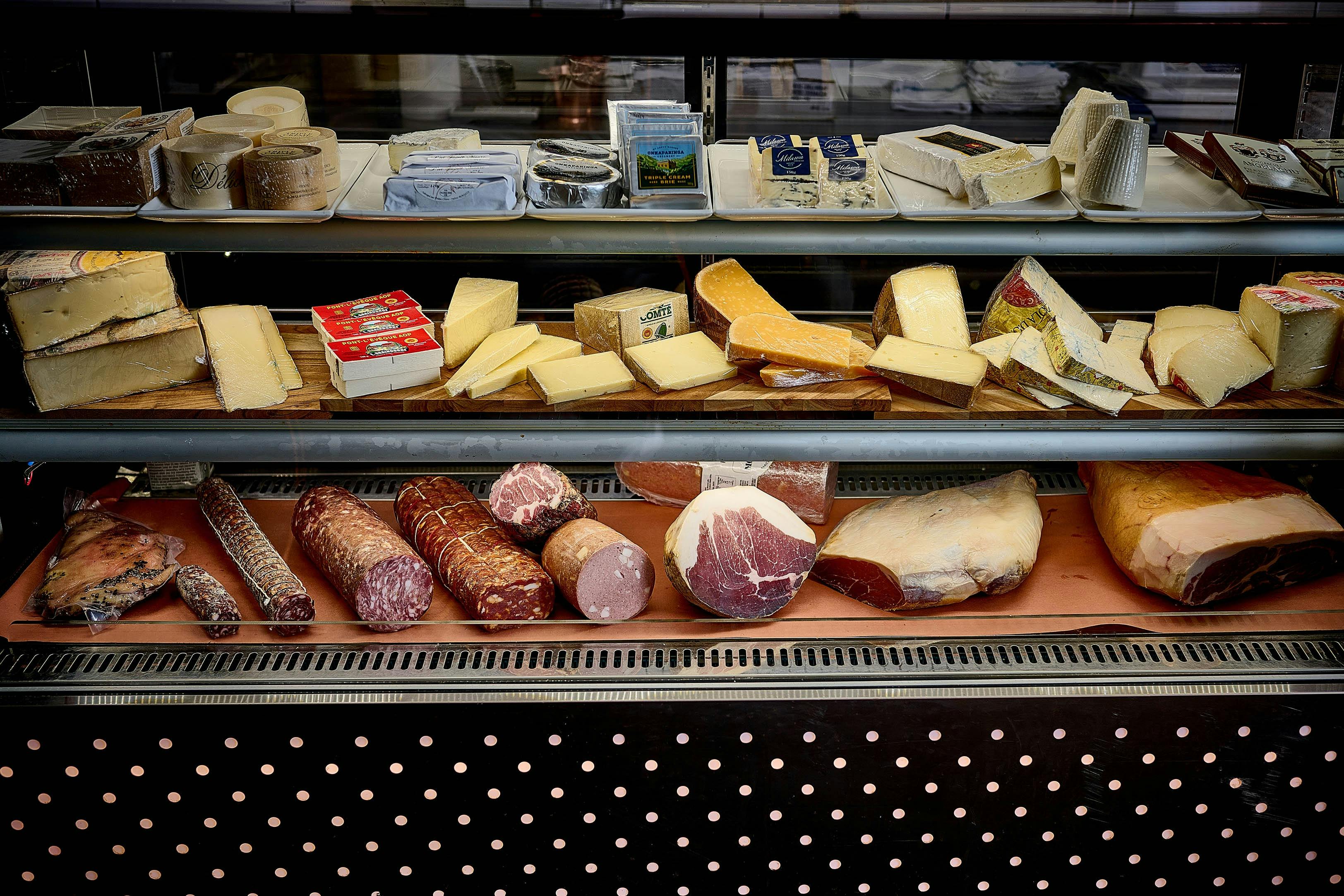 Deli display of cheeses and cured meats