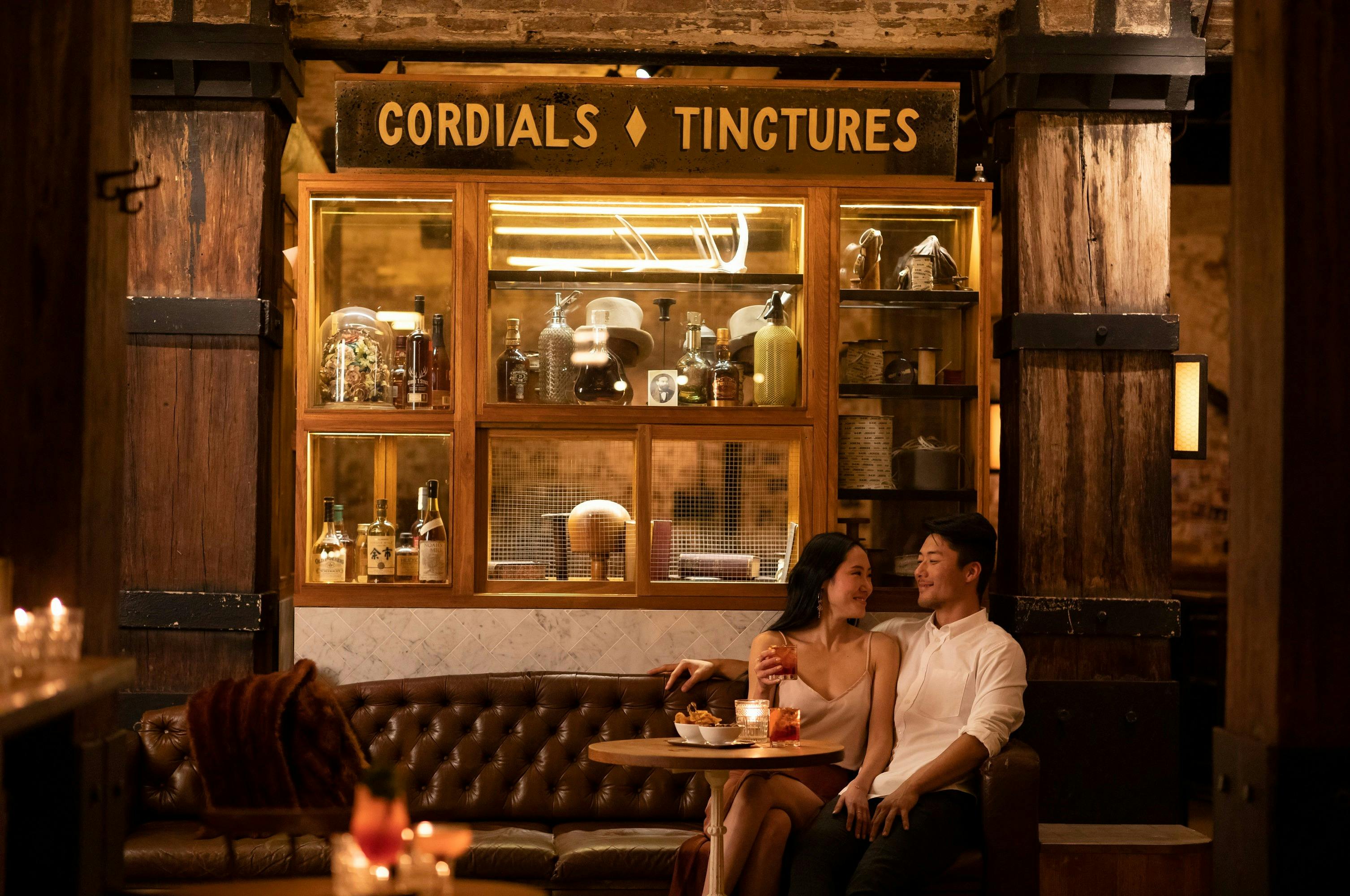 Couple enjoying bar snacks and cocktails at Palmer and Co., Sydney
