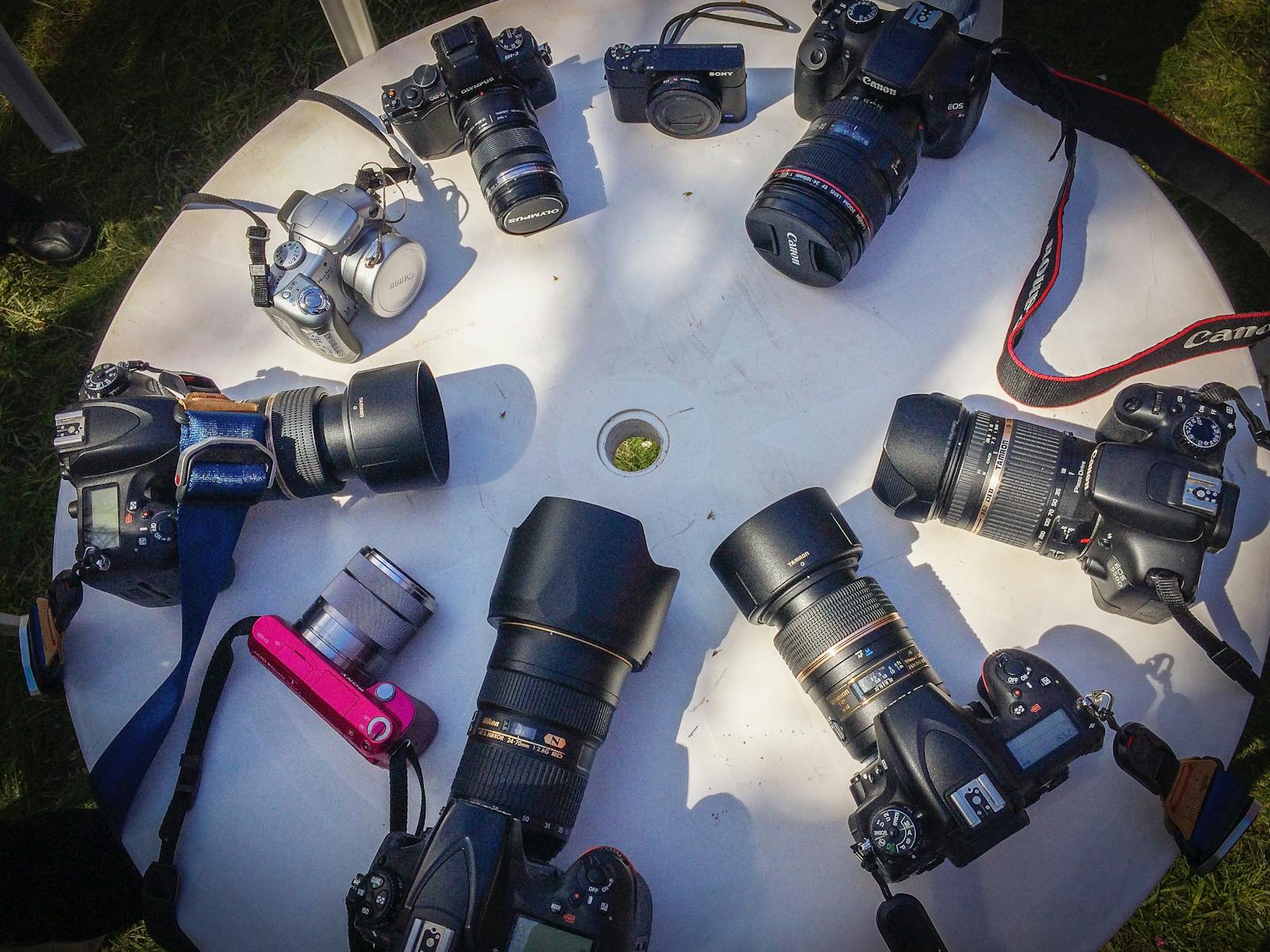 A range of digital cameras on a table