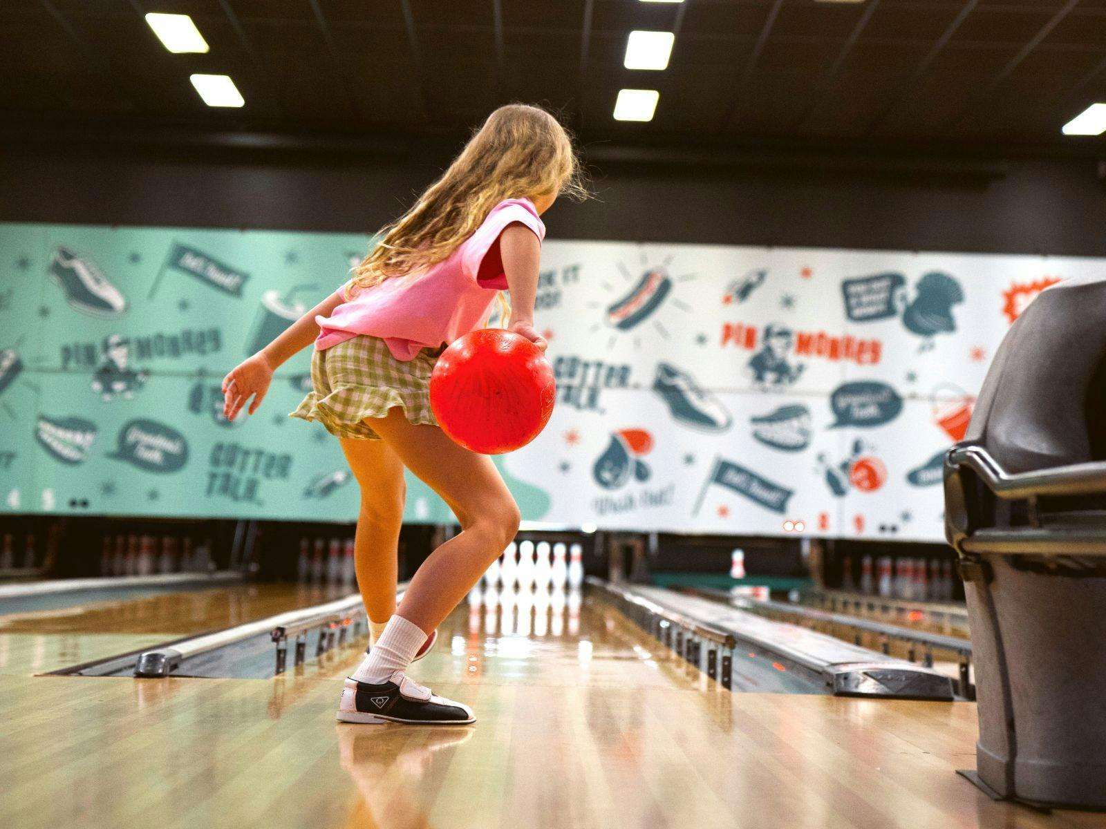 A girl playing tenpin bowling