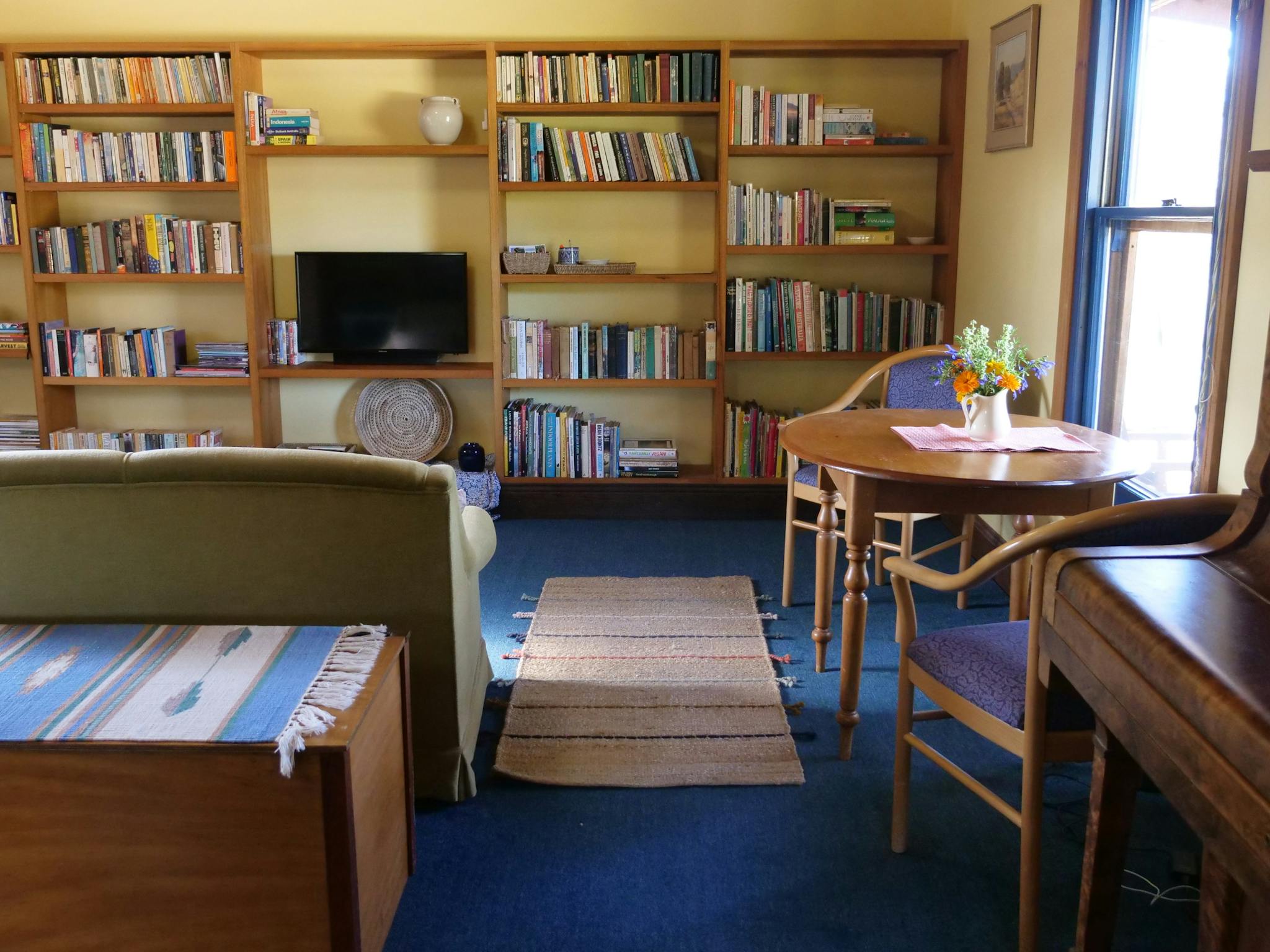 Living area showing extensive bookshelf and abundant books