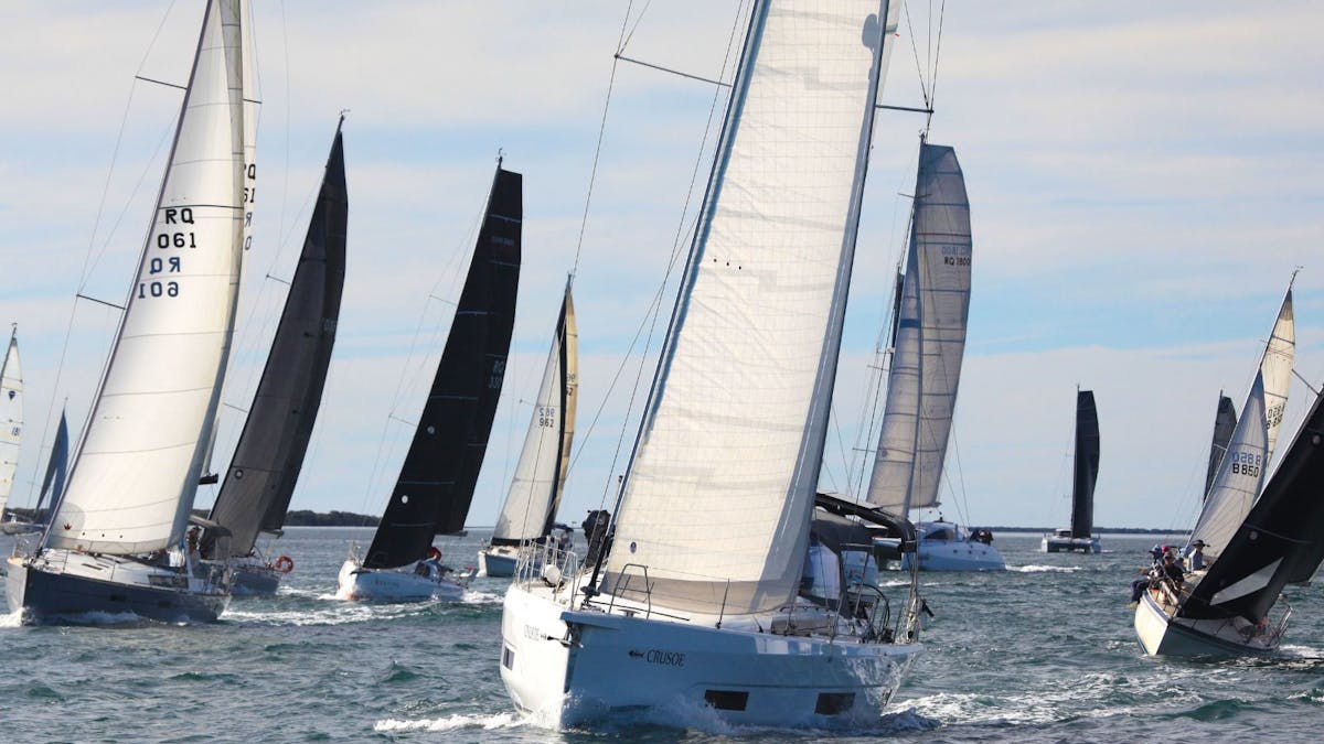 A fleet of large yachts racing