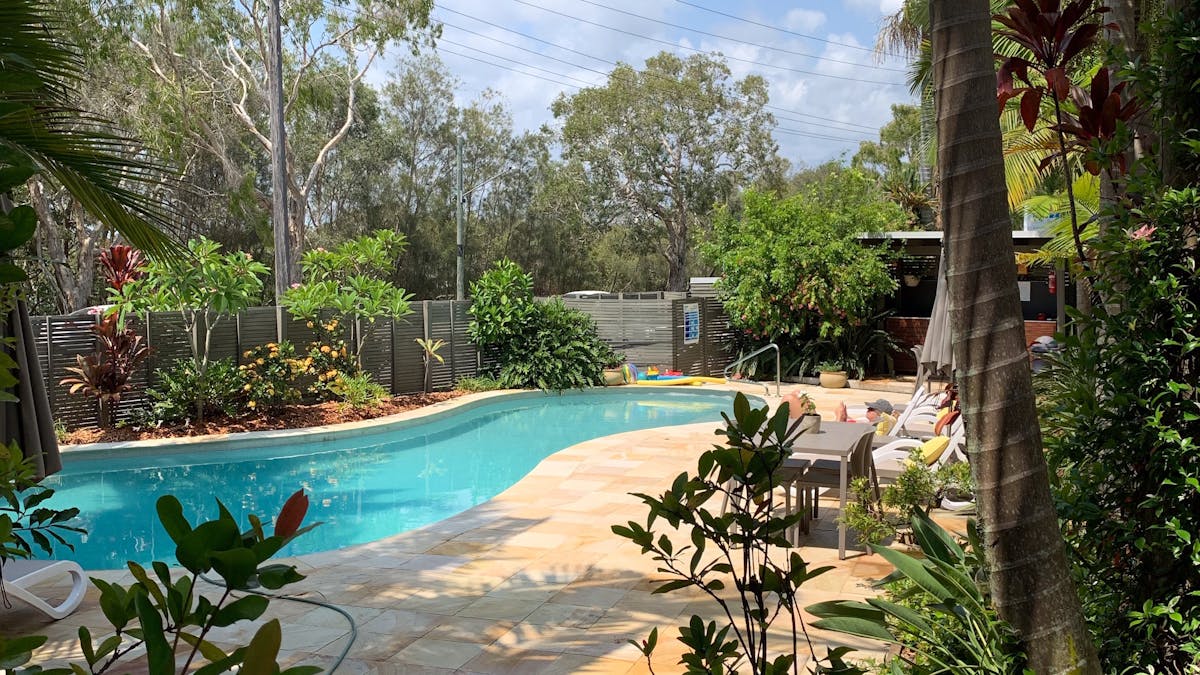 Outdoor and BBQ area surrounded by tropical gardens