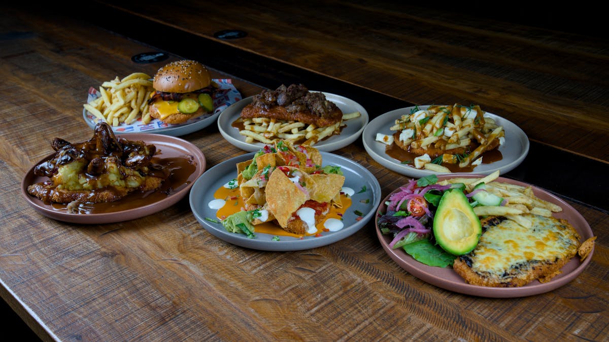 6 plated chicken Parmies with various toppings 6 plated chicken Parmies with various toppings