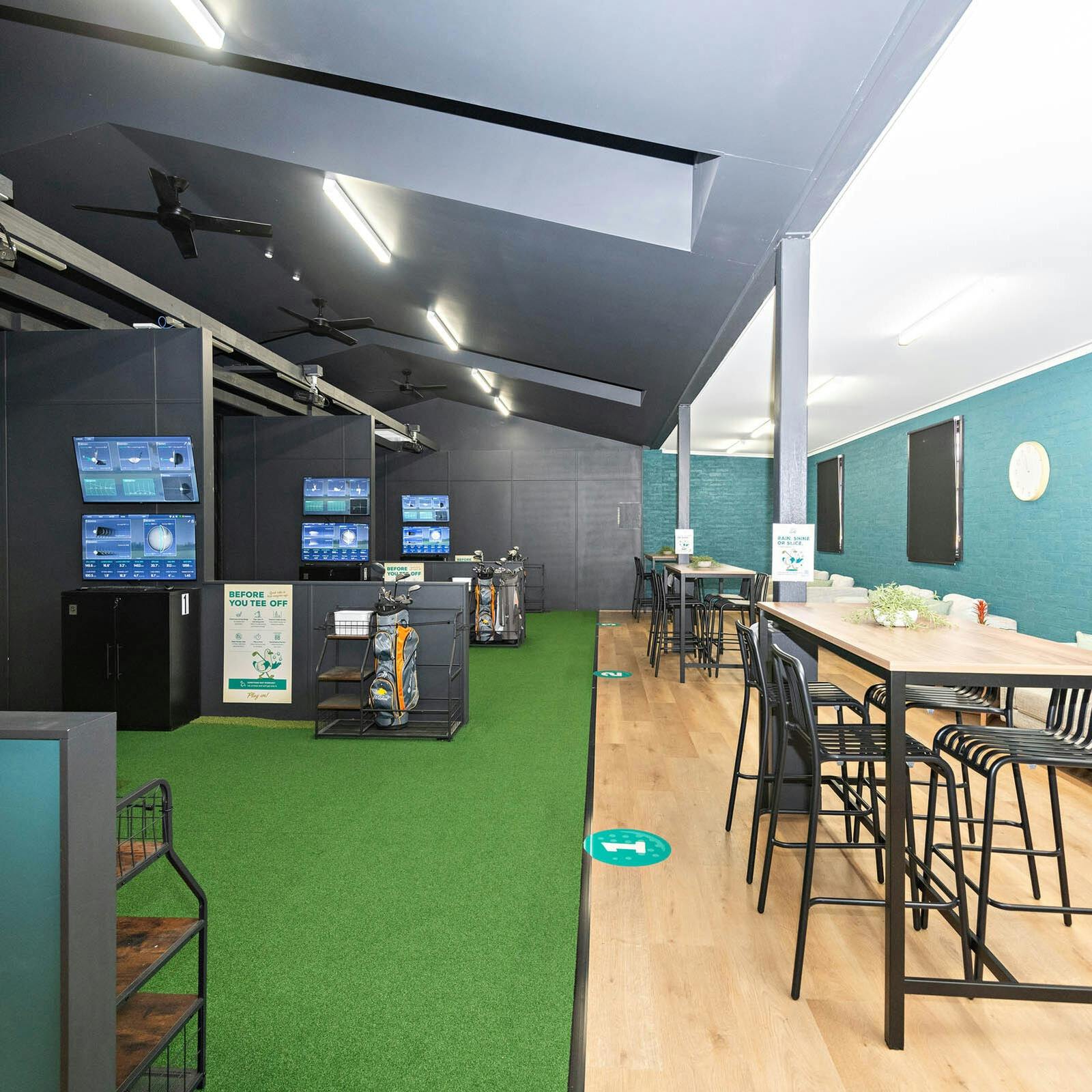 Indoor golf simulator and seating area at Batemans Bay Marina Resort