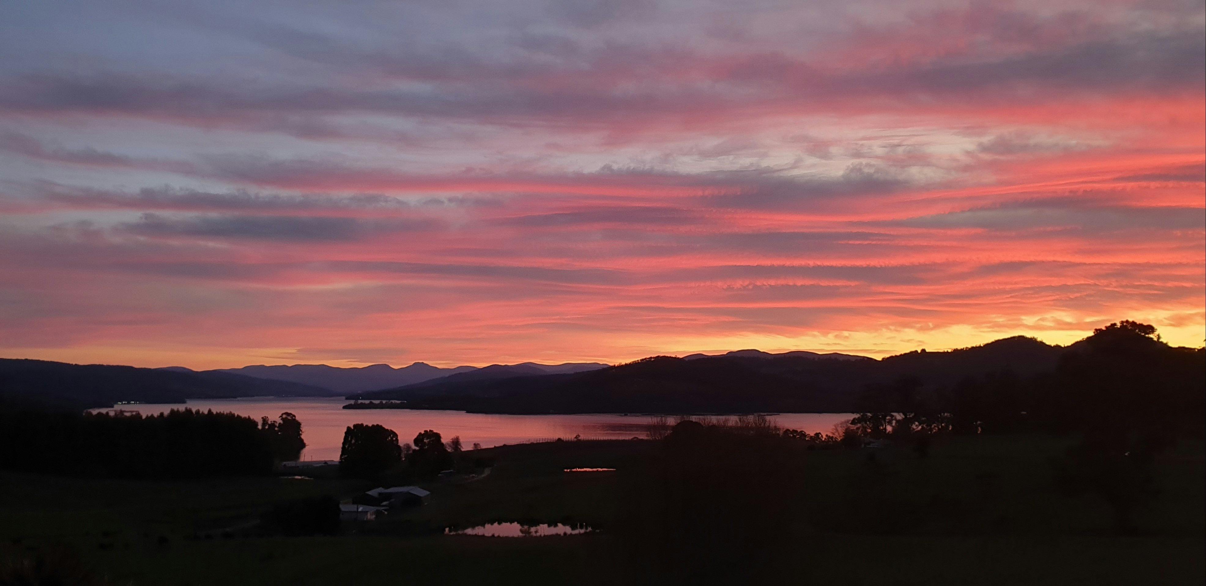 Sunrise from the verandah looking down the Huon River towards Sleeping Beauty and Mount Wellington