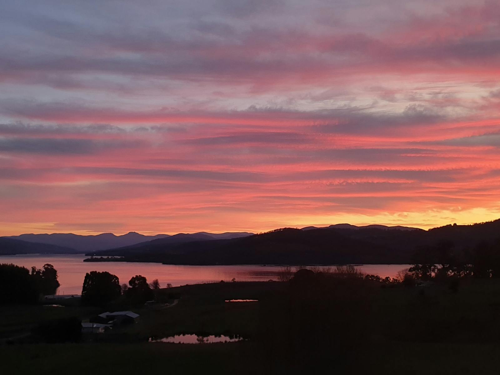Sunrise from the verandah looking down the Huon River towards Sleeping Beauty and Mount Wellington