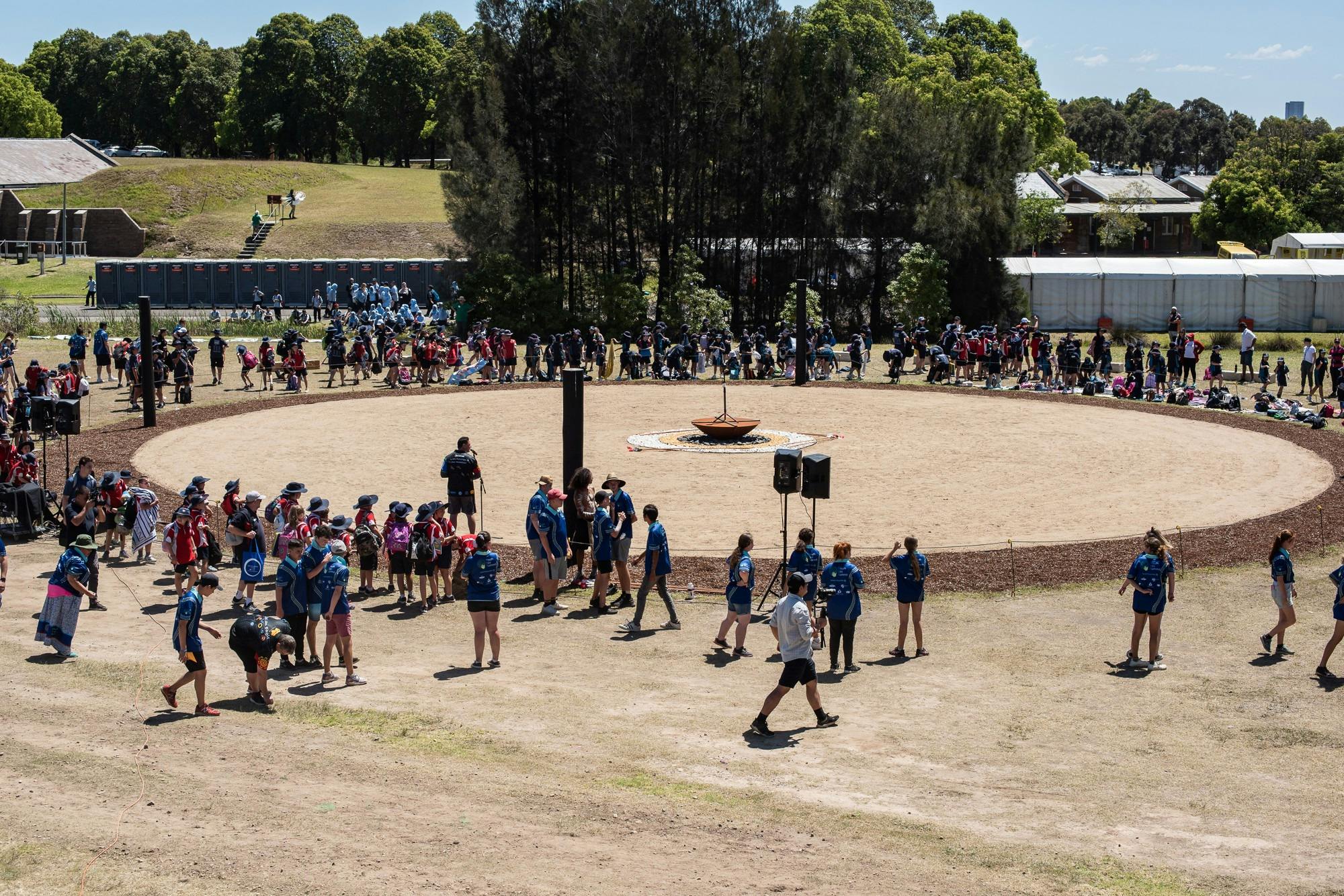 Birds eye view of a crowd of people surrounding the dance ground.