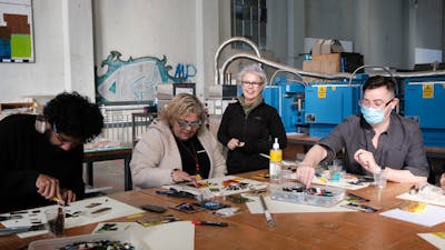 Participant arranging glass tiles to make a glass tile