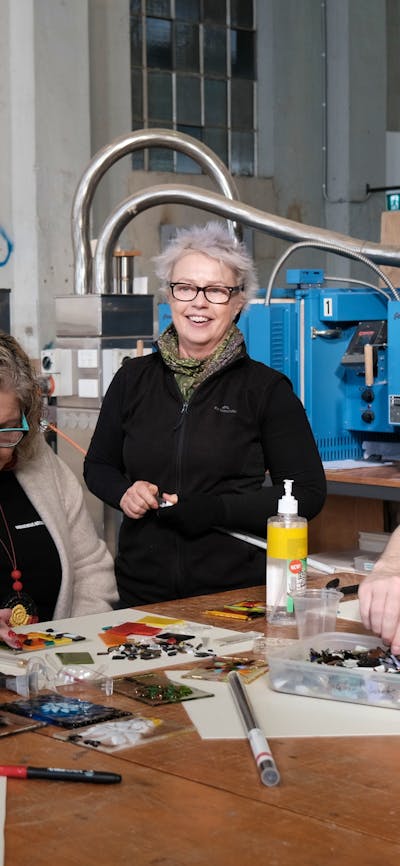 Participant arranging glass tiles to make a glass tile