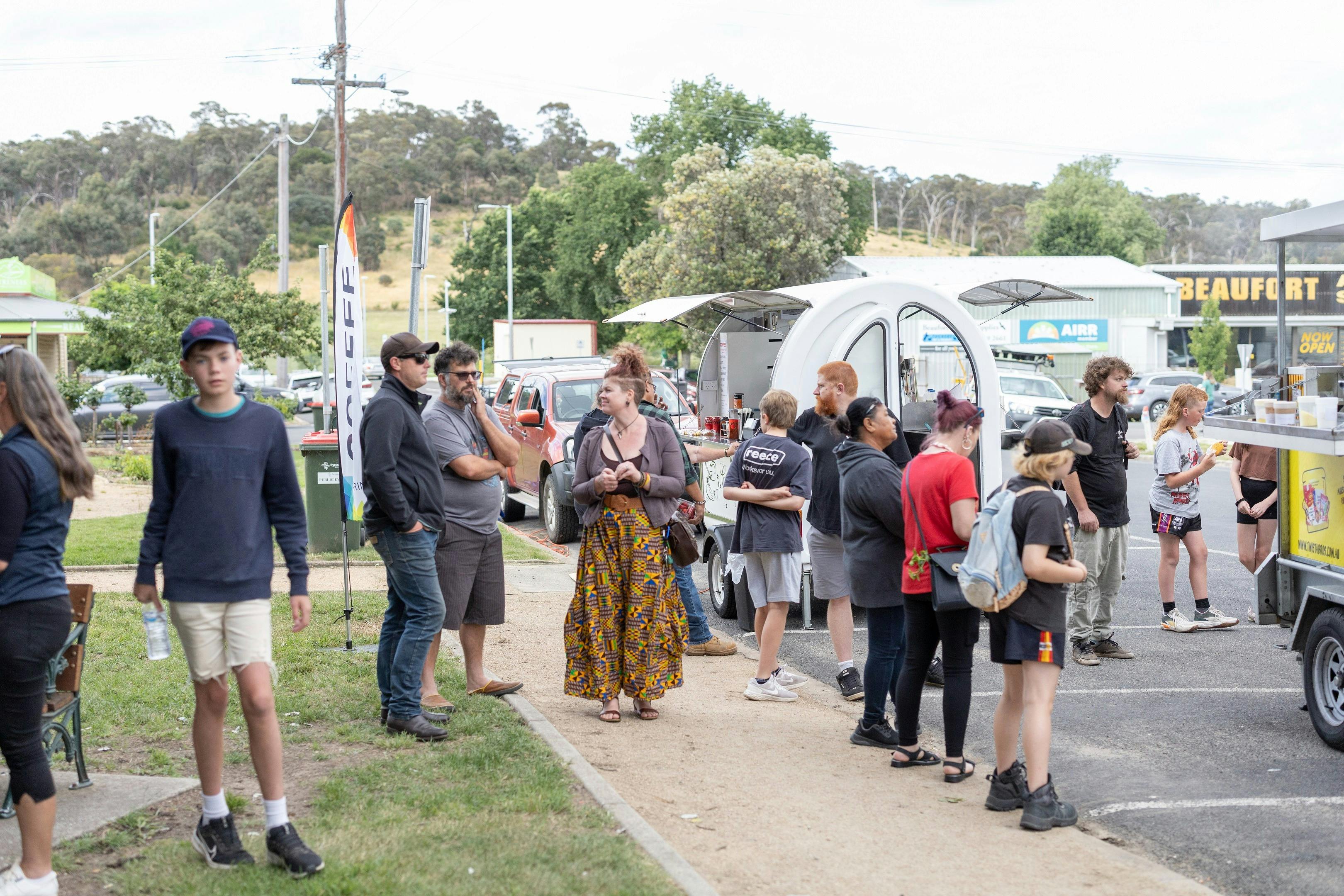 People gathered around the food trucks