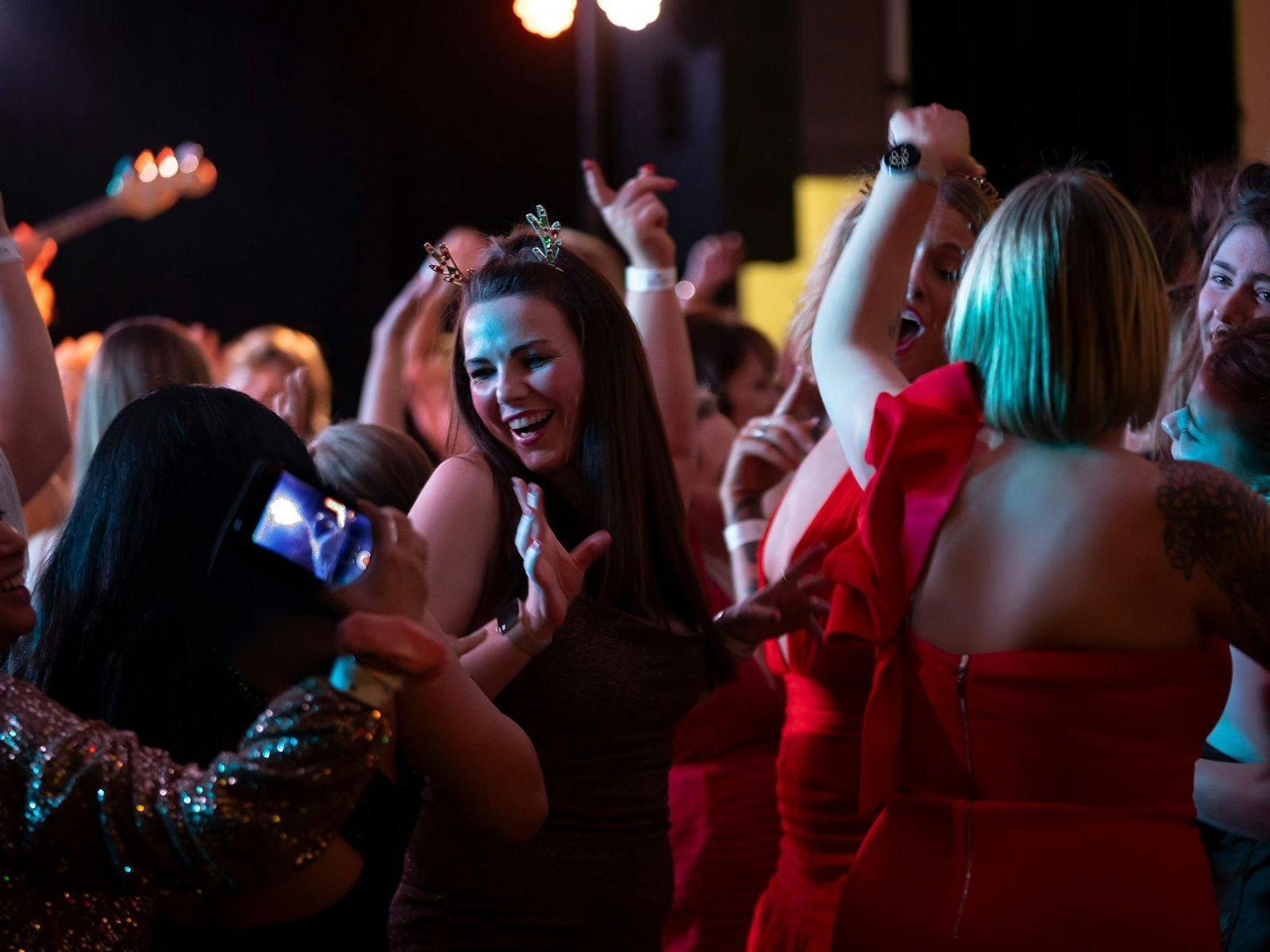 Girls dancing in a crowd at a Christmas concert