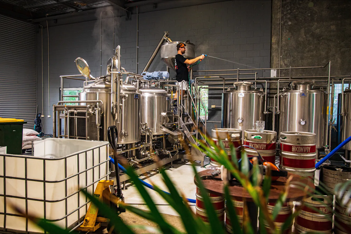 Brewer busy making ice cold fresh craft beer with the stainless brew kit.