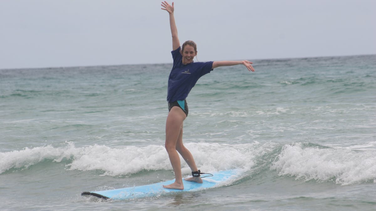 Pure stoke—a surf student celebrates riding a wave for the first time.