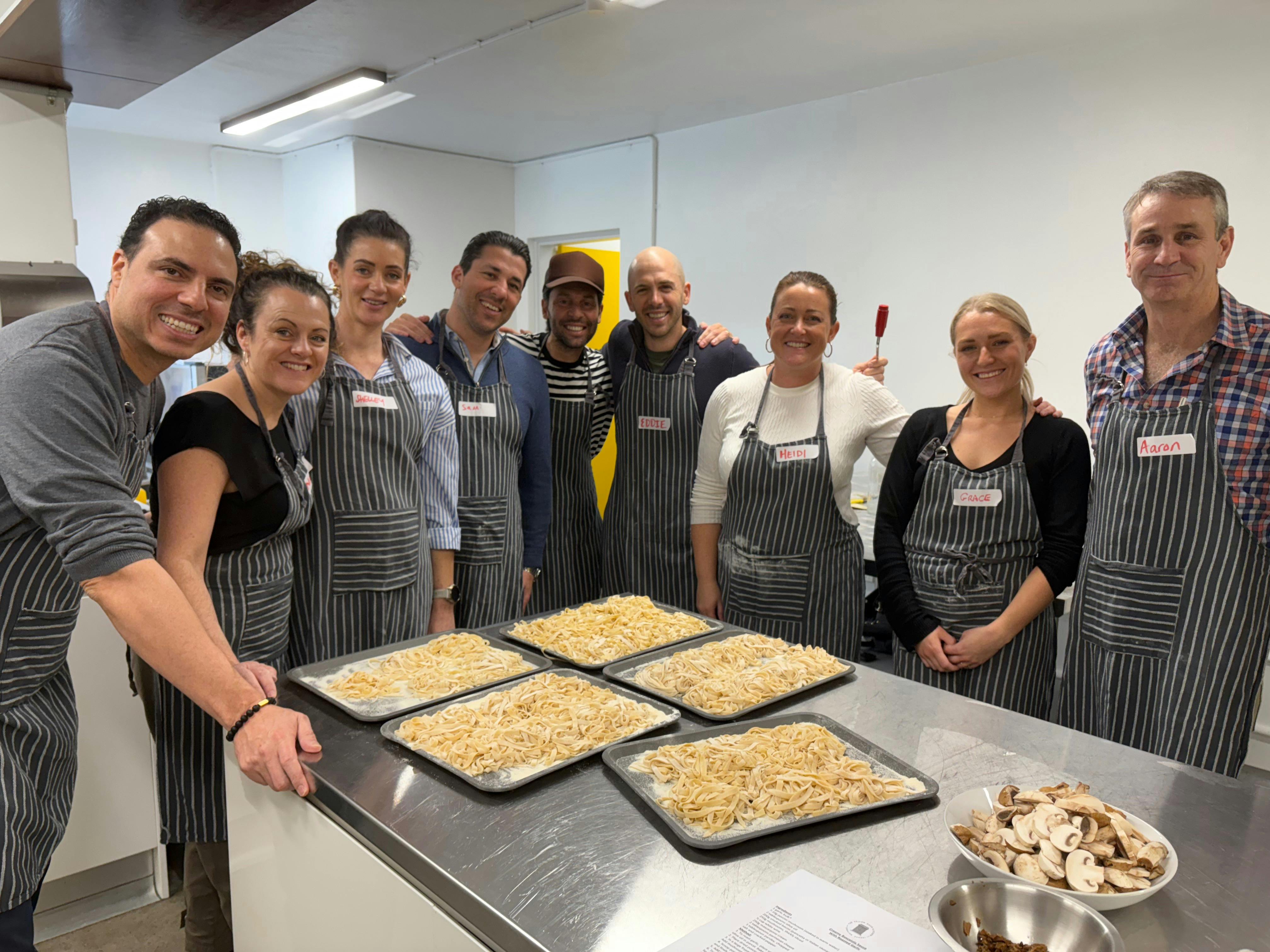 Photo of team in The Yellow Door Kitchen with the fresh pasta they have just made