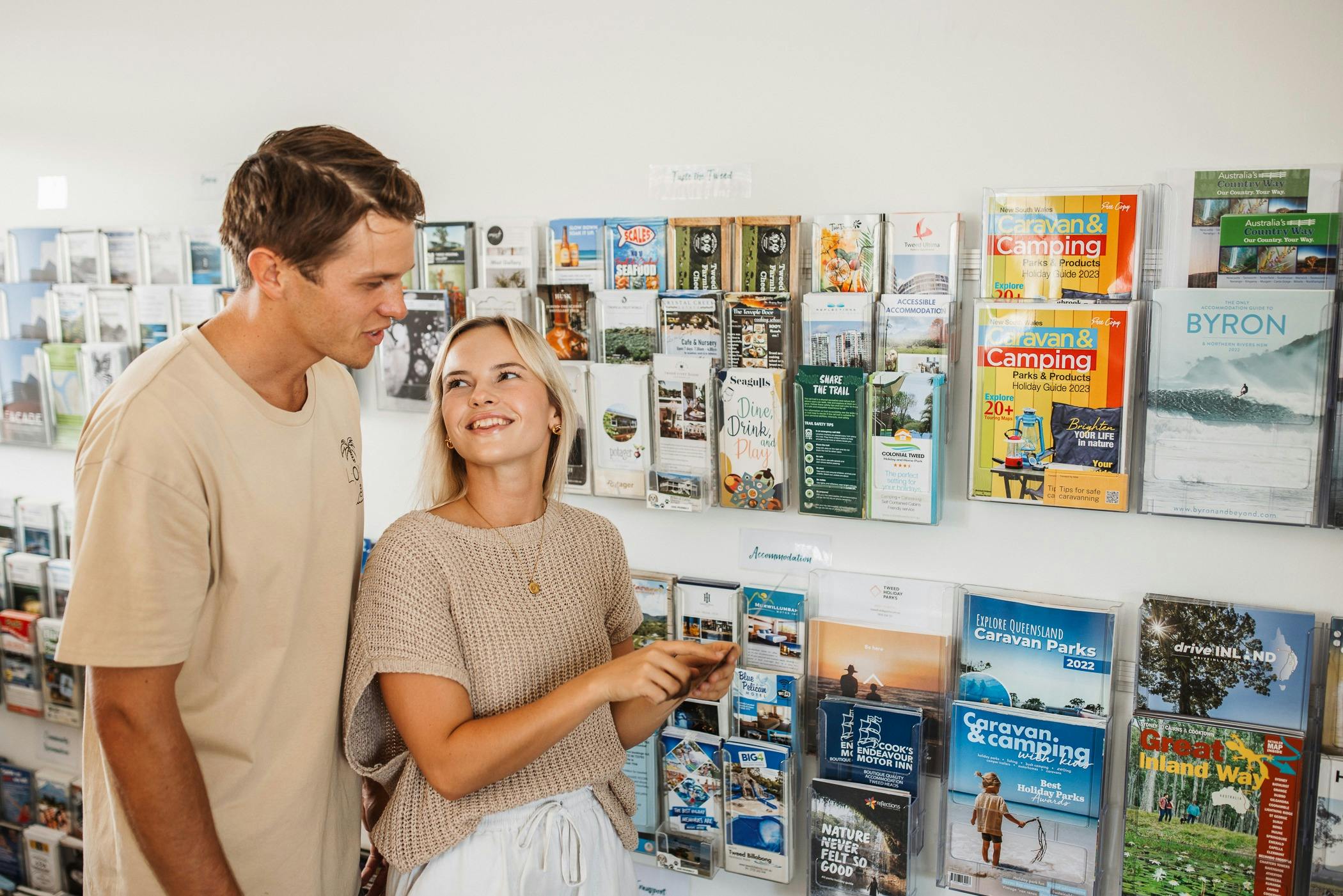 Couple looking at brochures in visitor information centre