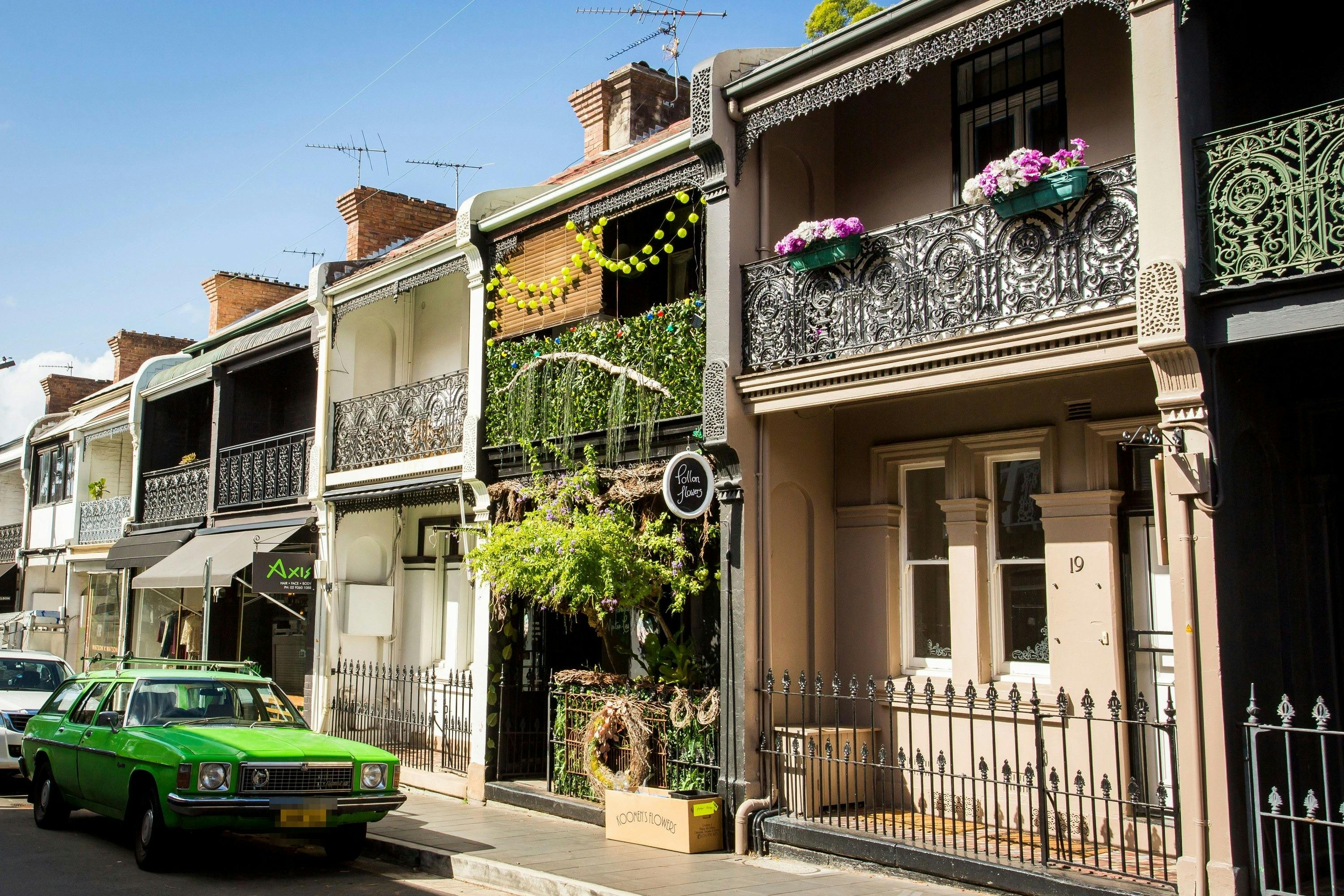 Colourful terraces and a green vintage car in Paddington, Sydney.