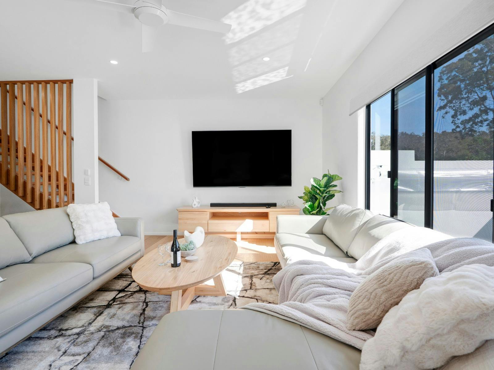 Spacious living room with balcony access and pool views
