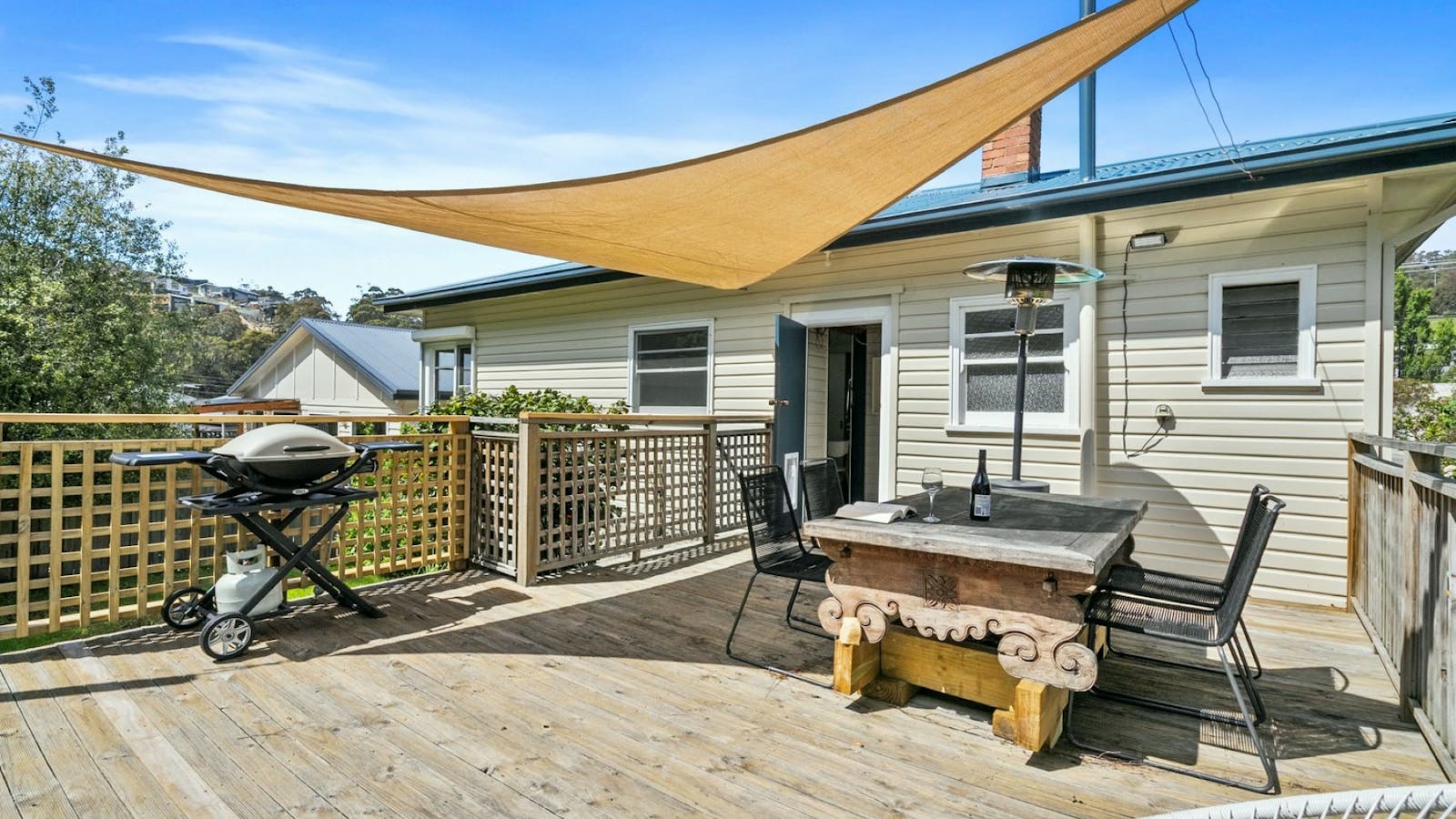 Deck with BBQ and table and chairs and heater