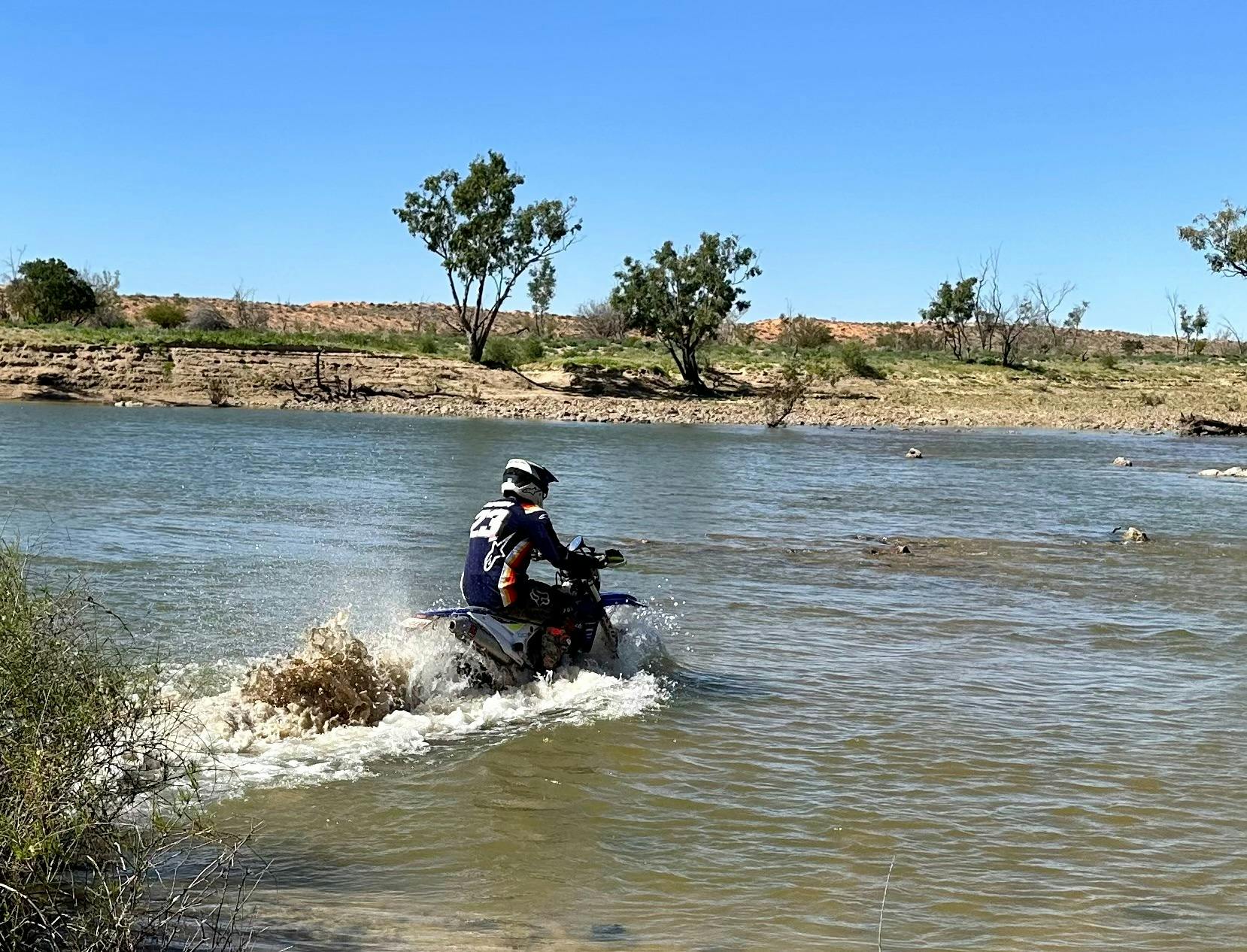 Rider crossing Eyre Creek Bypass when in flood