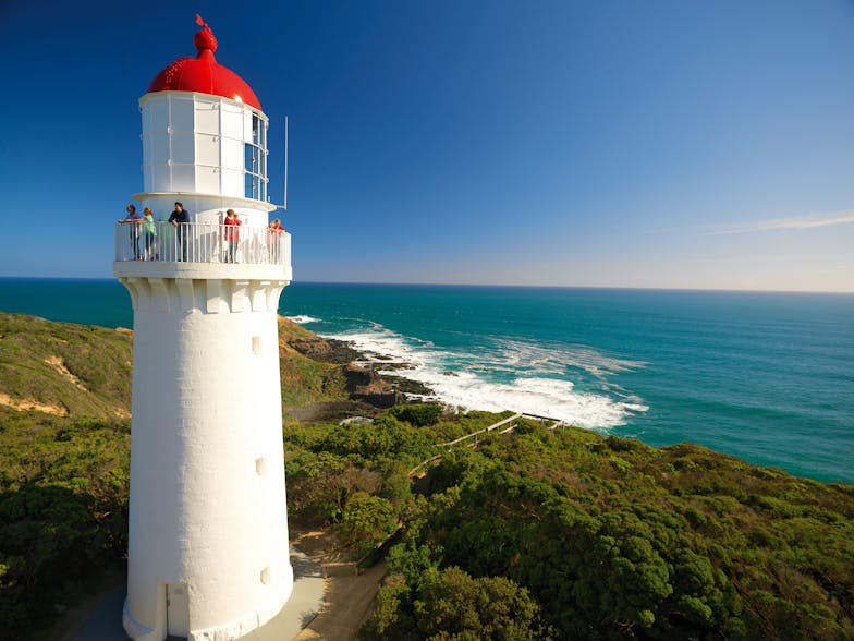 Cape schanck lighthouse against backdrop of sky and ocean.