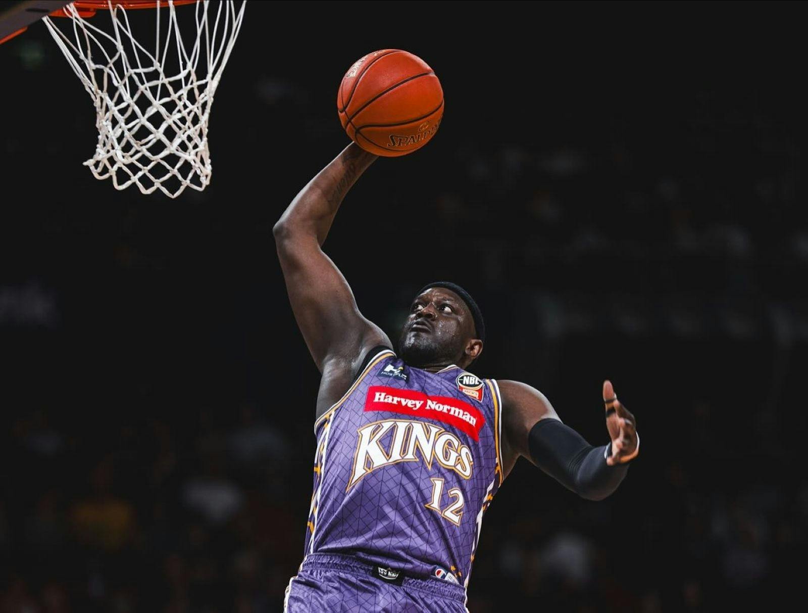 Sydney Kings player and opponent on court