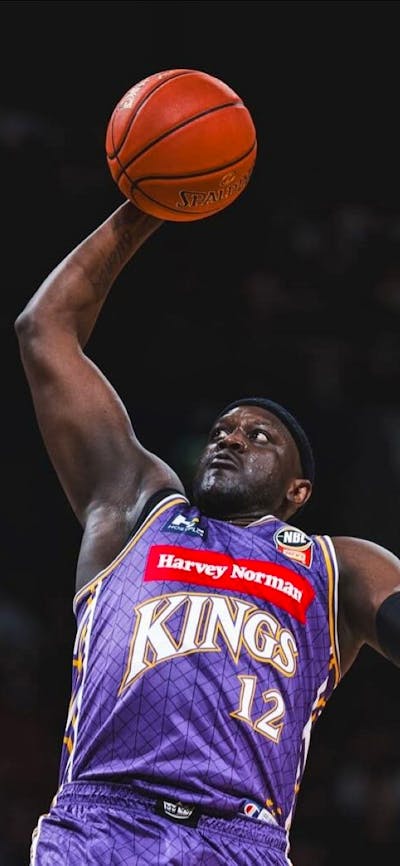 Sydney Kings player and opponent on court