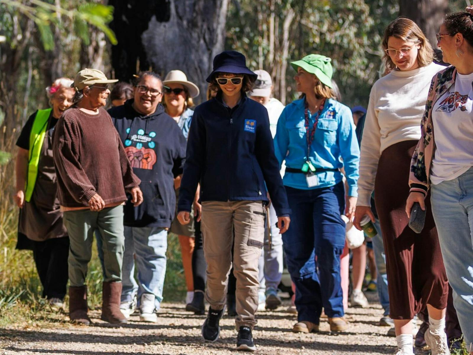 A group of people being led on a walk with a tour guide in front
