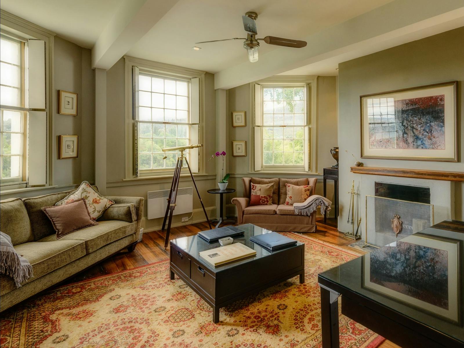 Library reading room with fireplace and artwork