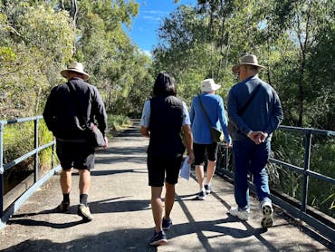A guide walking and talking with visitors along the wetlands walk