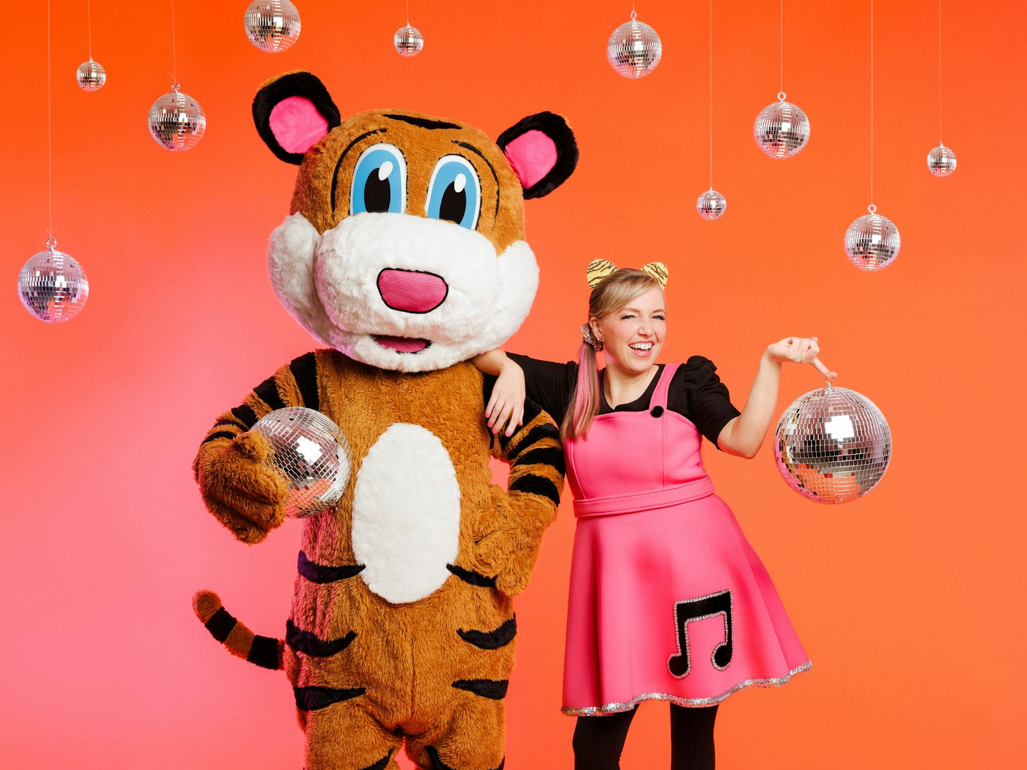 A picture of Pevan and Sarah holding and surrounded by disco balls