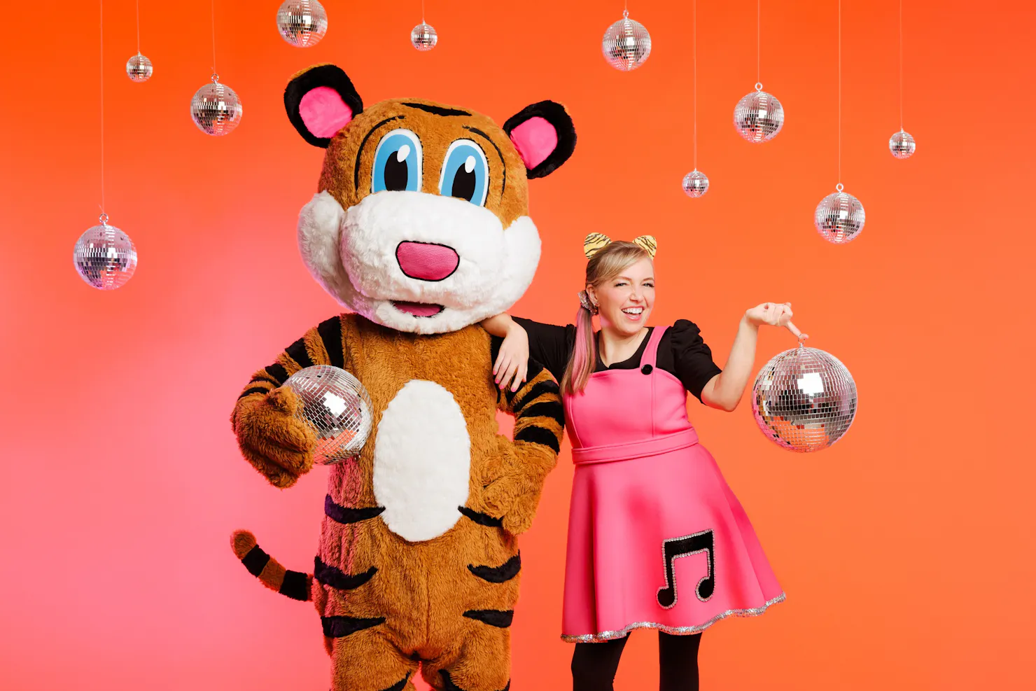 A picture of Pevan & Sarah holding and surrounded by disco balls