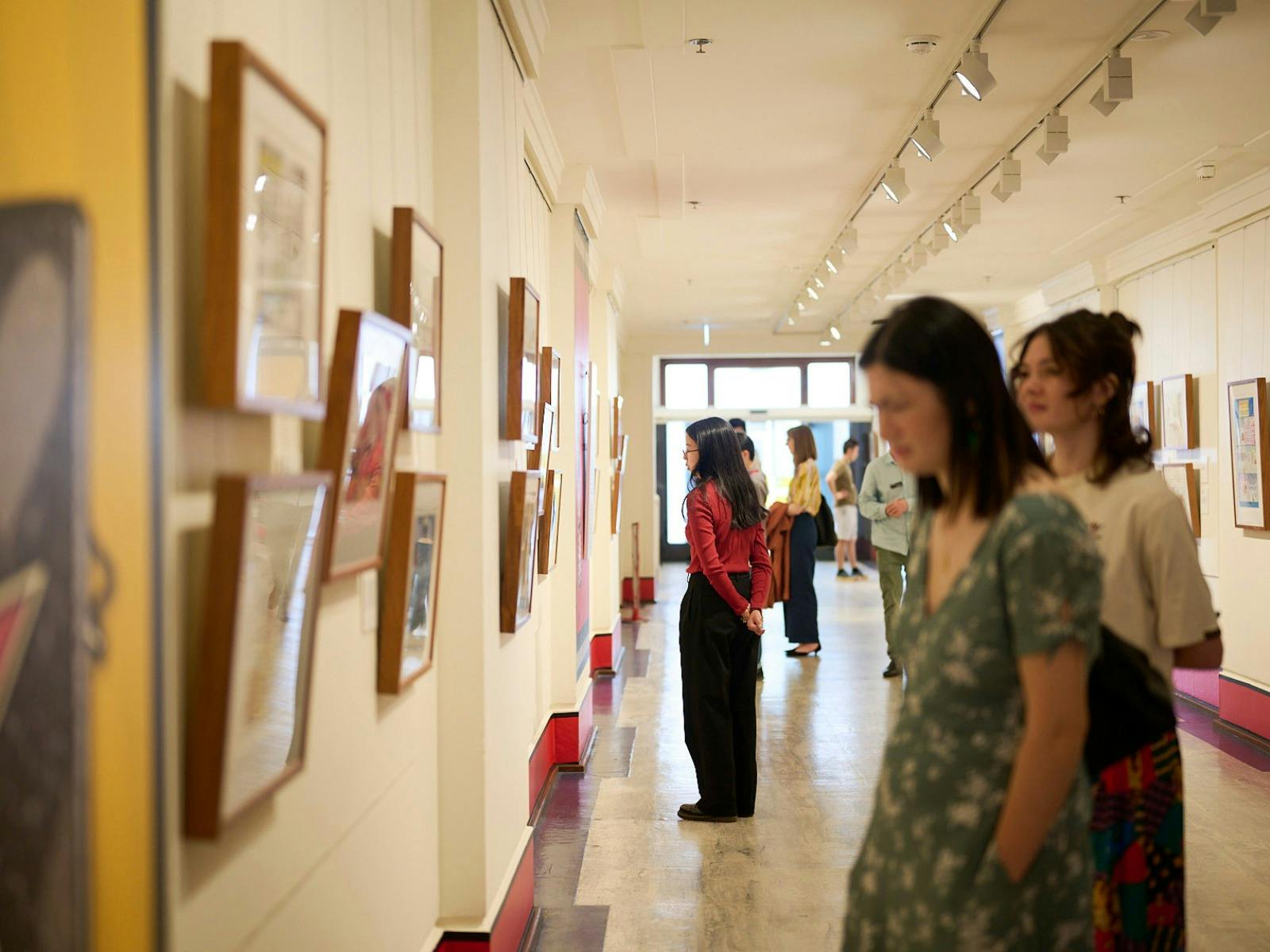 People view artwork in gallery.