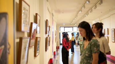 People view artwork in gallery.