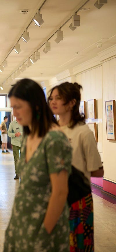 People view artwork in gallery.