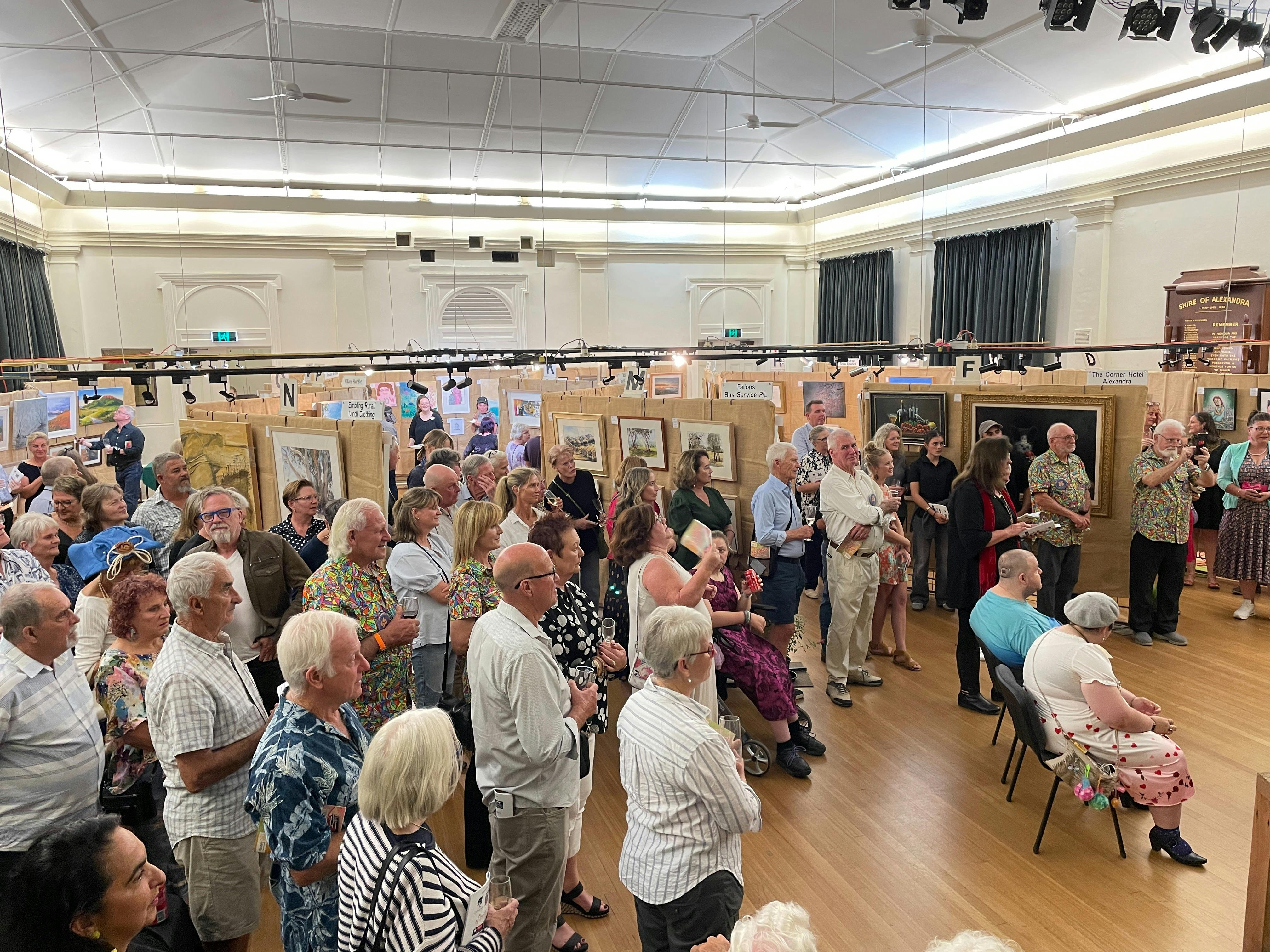 People looking at artworks