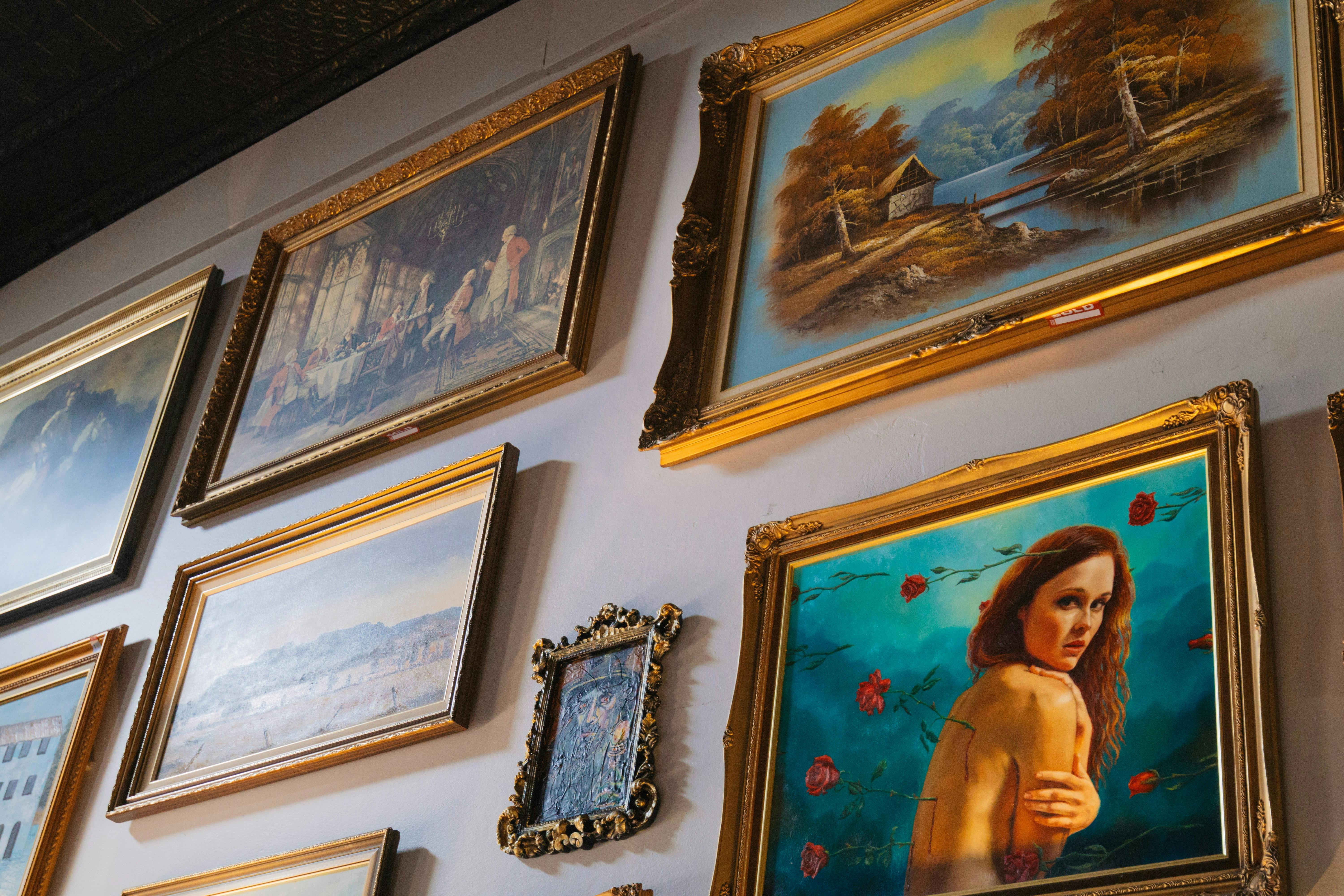 An image of artworks on a wall in House VanChaos Gallery in South Grafton , bright colours and frame