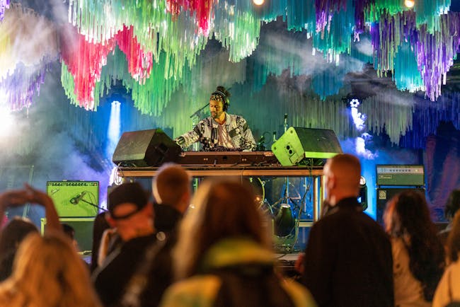 DJ playing a set on stage at FUSION