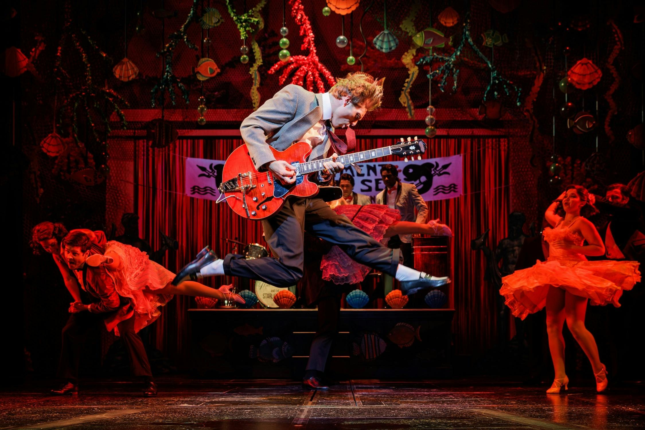 Axel Duffy as Marty McFly playing the guitar while jumping.
