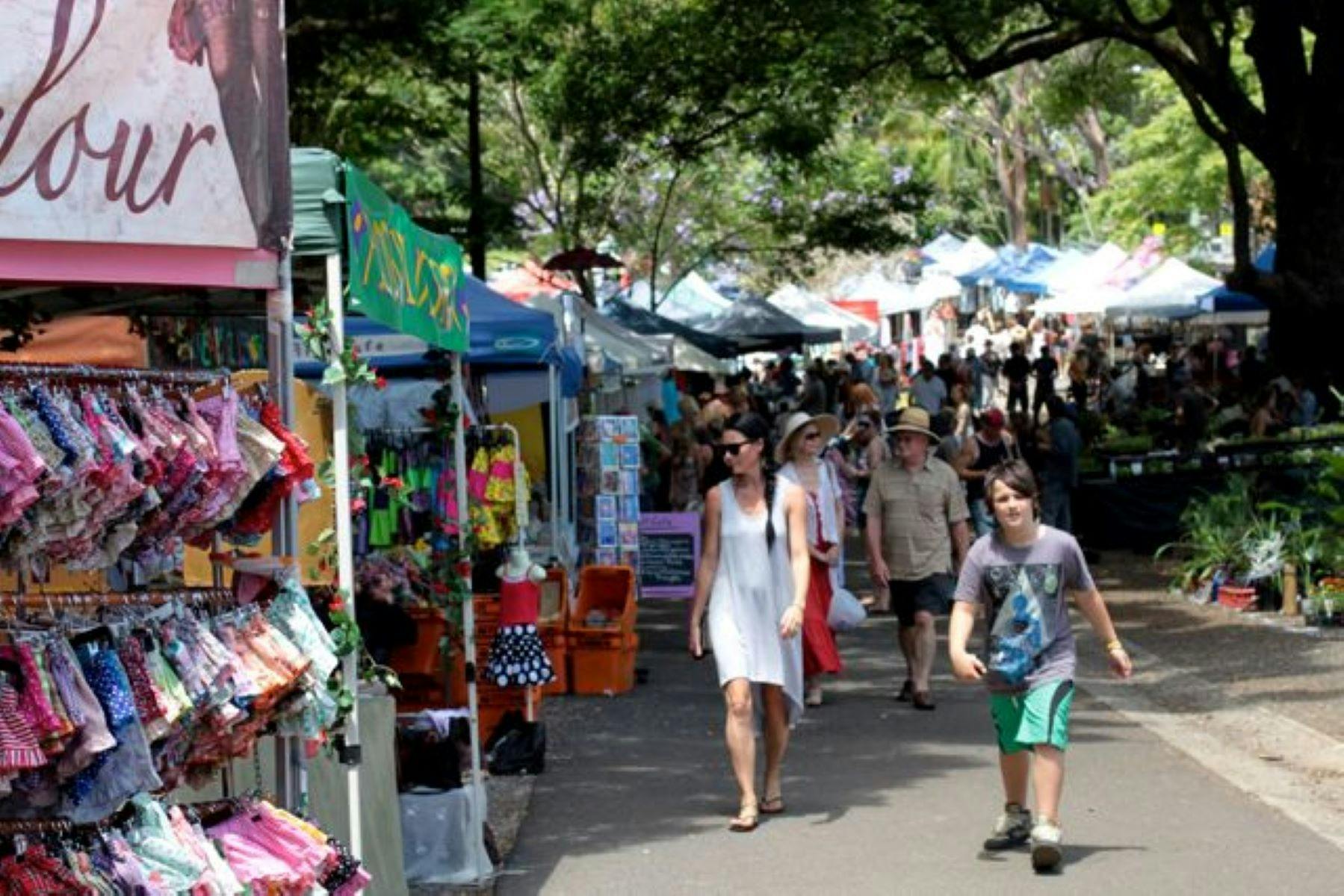 Image of multiple stores and customers strolling through the Bangalow market