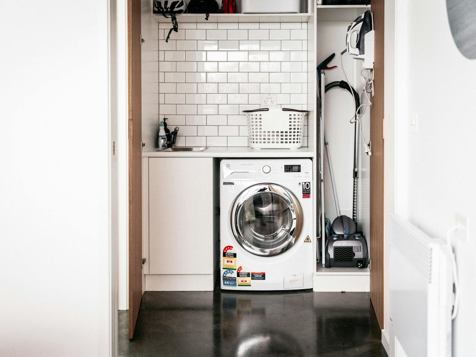 Laundry showing washer/dryer, iron and board.