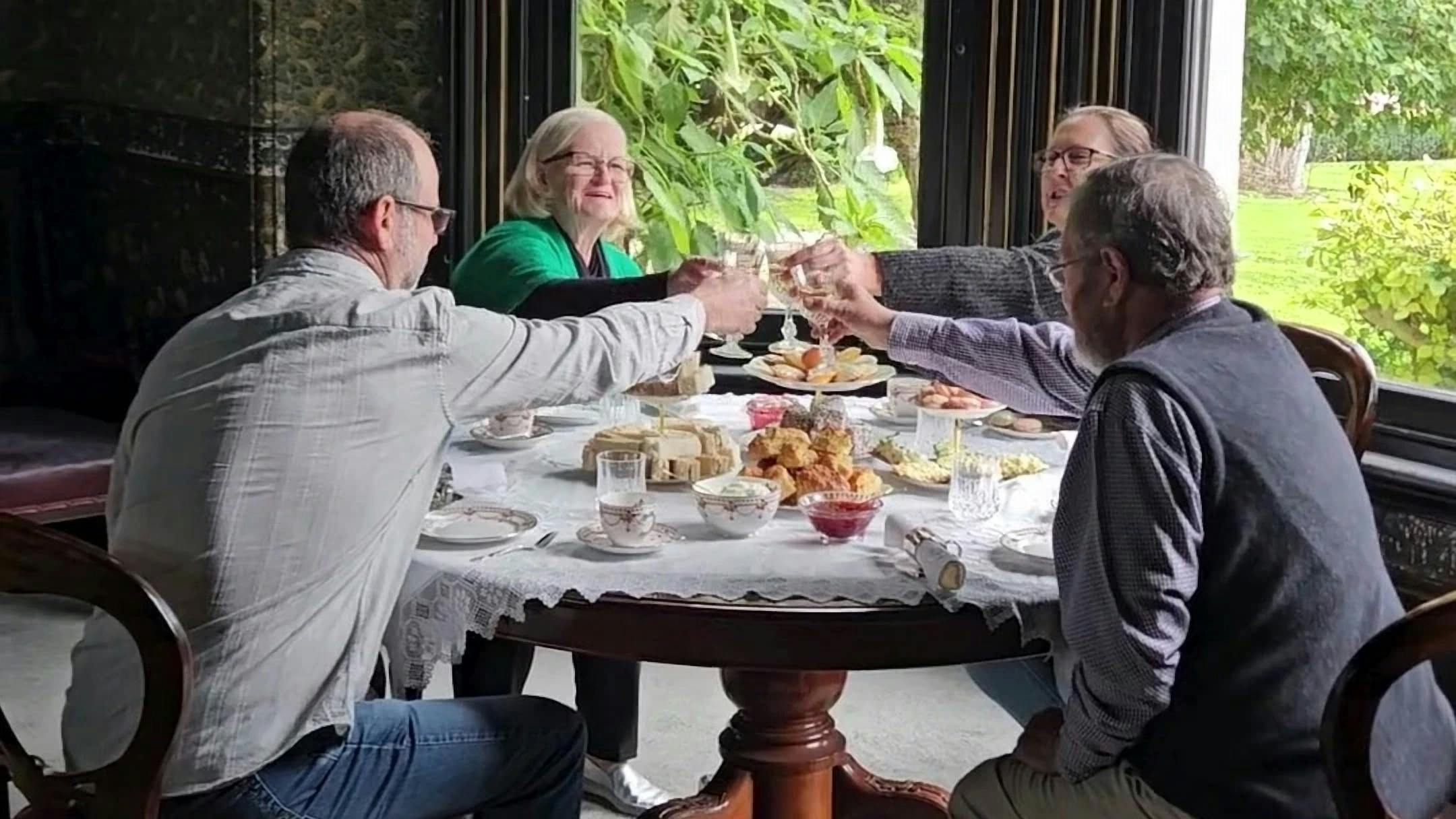 Guests raising a toast over high tea at Yallum Park's dining room bay window