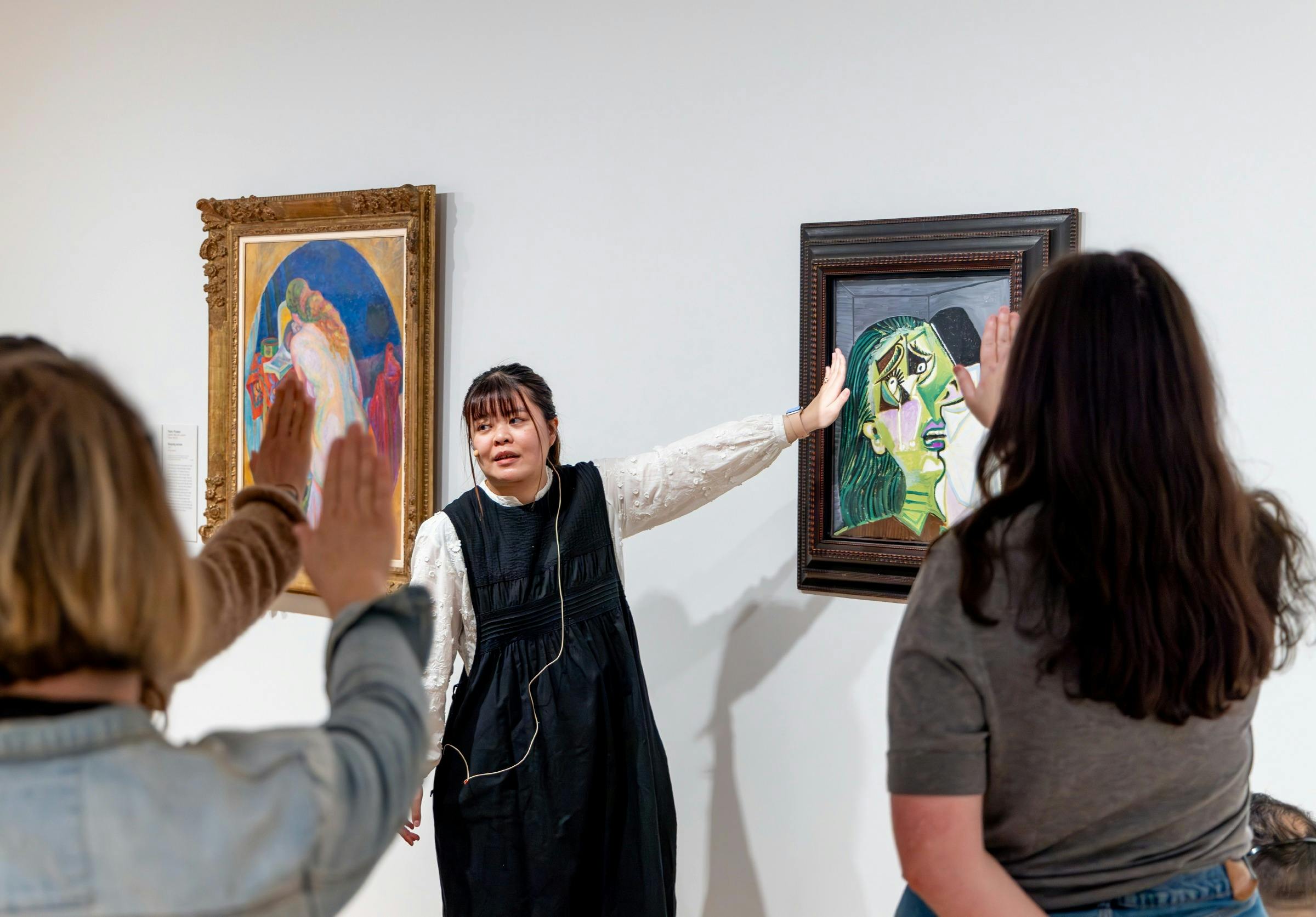 Guide describing artwork on a tour