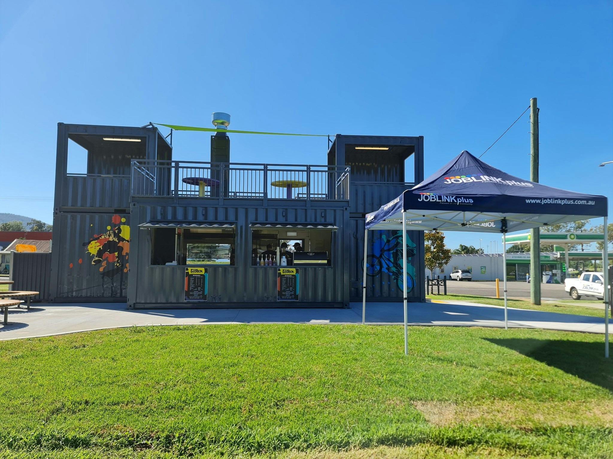 Full picture of the cafe on a bright sunny day with the Joblink Plus marquee providing shade