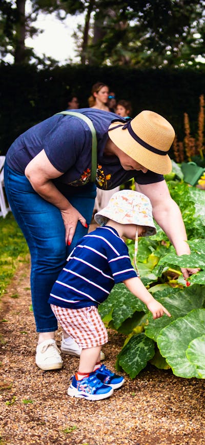Parent and child inspecting gardens at Harvest Day Out