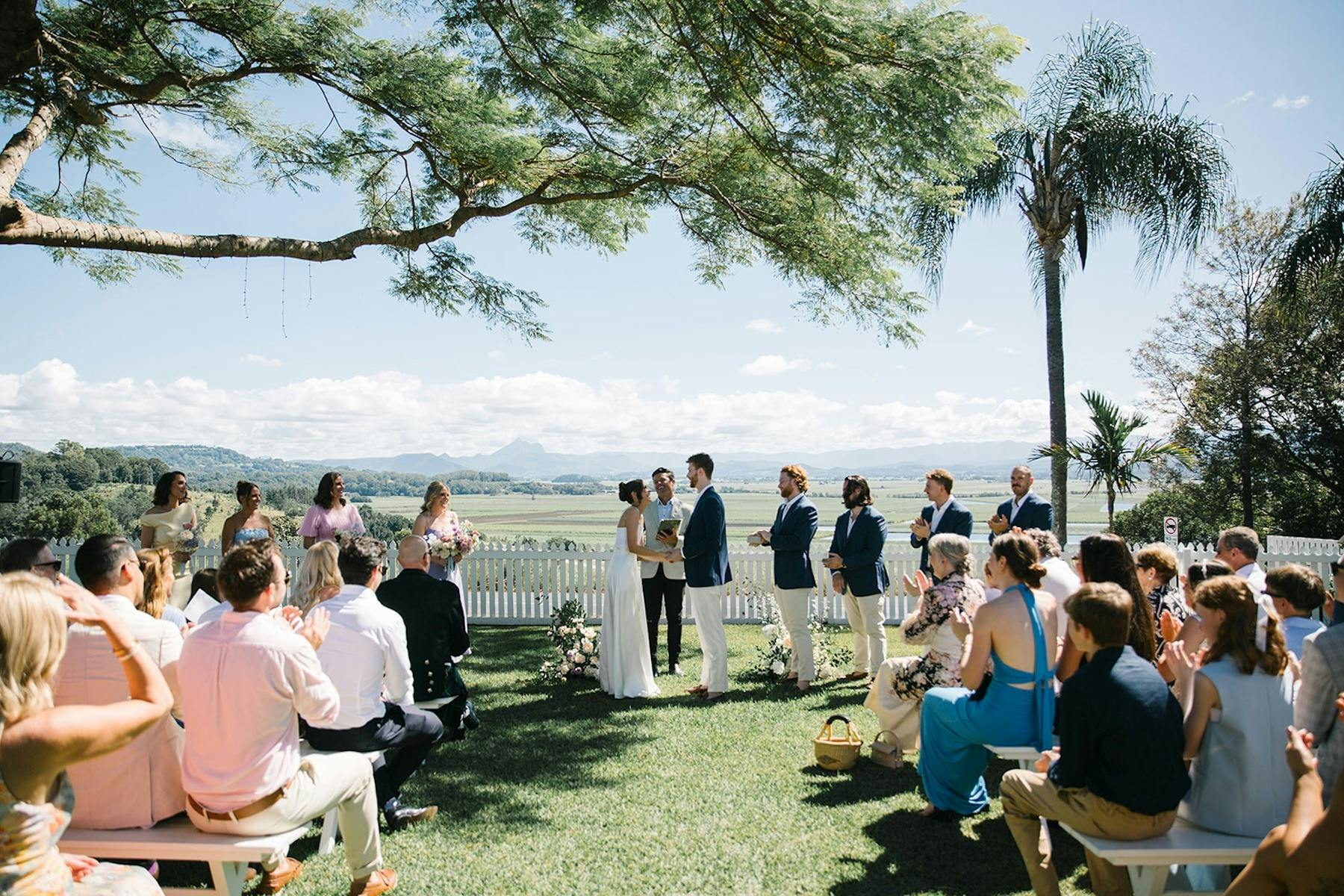 bride and groom getting married with celebrant in the garden with vast views behind