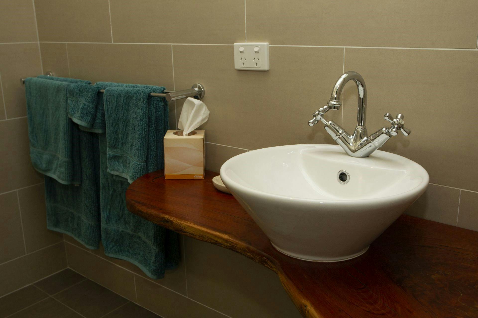 Photo of the bathroom sink with towels hanging up