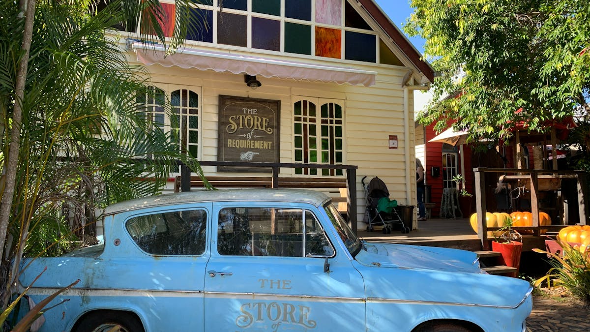blue car in front of shop