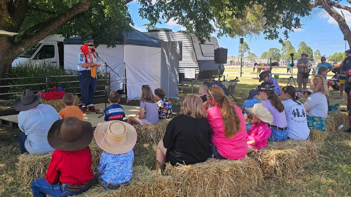 Lollipop clown entertaining children